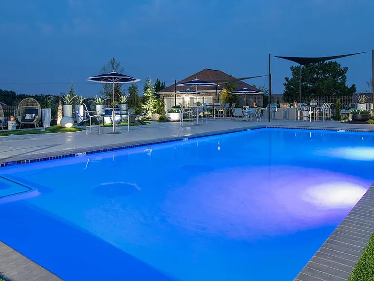 Revel in the captivating allure of the pool at night, where residents can enjoy an elegant and revitalizing ambiance under the stars.