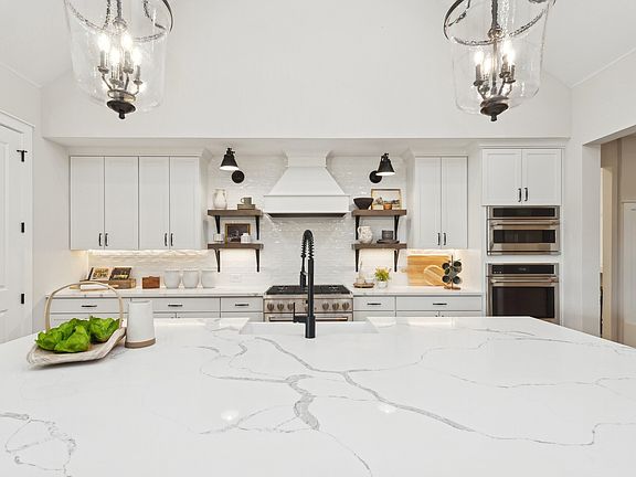 Kitchen with floating shelves and quartz countertops