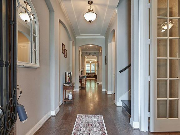 Rich wood floors and the oversized foyer captivate your attention as you welcome through the door.