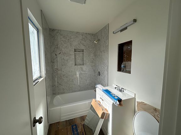 Bathroom, almost finished. New marble tile, tub and cabinet