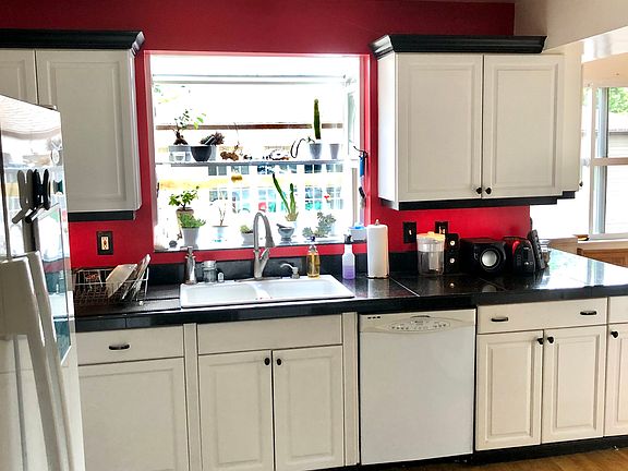 A large kitchen with lots of countertops and cupboards.