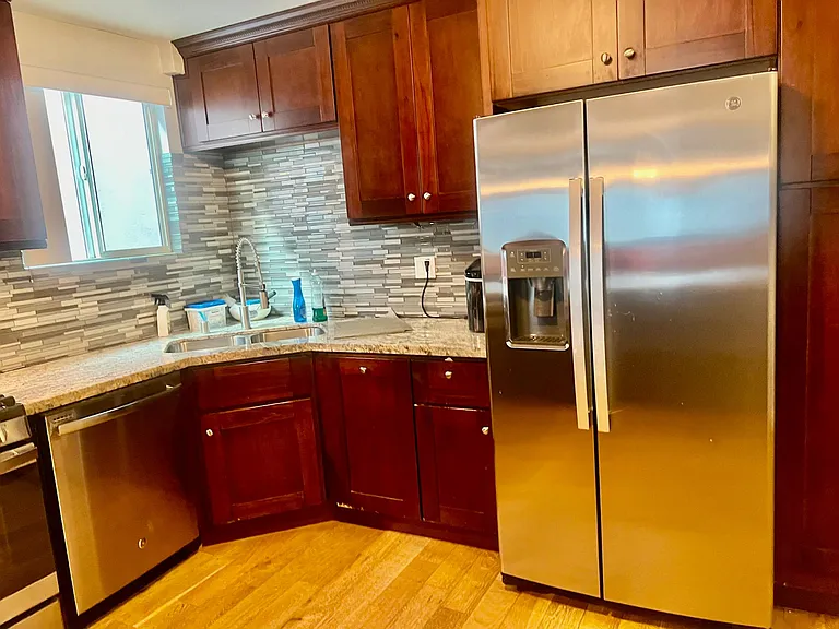 Full Kitchen w/ stainless steel appliances including Air Fryer Oven, Dishwasher, Refrigerator w/ Ice maker and built-in Microwave. Marble counter tops, Dark wood cabinets, Bamboo hardwood floors through out the Home. Kitchen has cooking essentials.