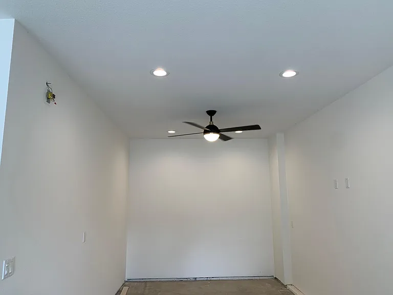 Enhanced lighting, electrical outlets, and air flow in tandem garage spot