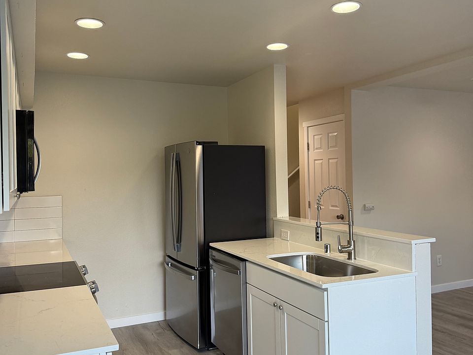 Kitchen with new counters, sink, and updated fixtures and appliances.