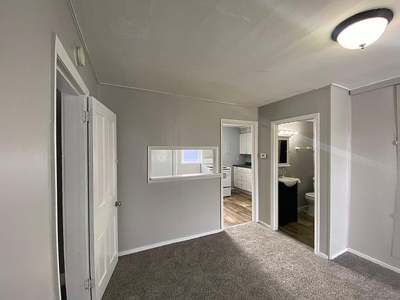 Living room looking into bathroom & kitchen