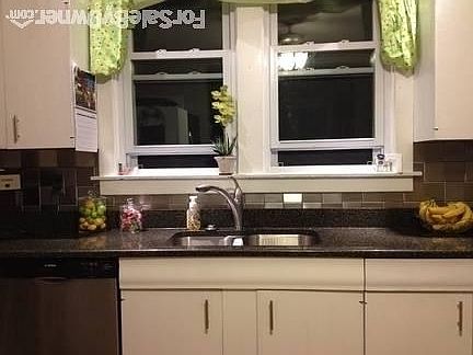 Recently remodeled kitchen
						:
						Black quartz counter with white cabinets give this room a stunning look