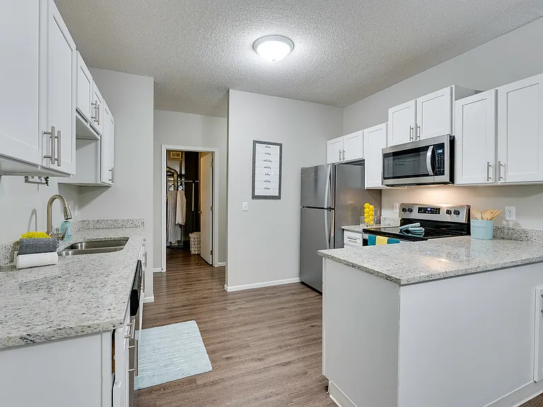 Renovated Kitchen With White Cabinetry & Stainless Steel Appliances