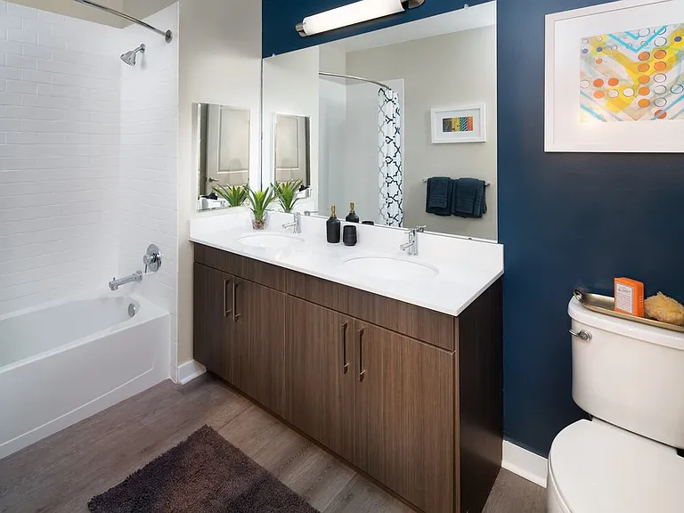 Avalon Package bath with espresso cabinetry, white quartz countertops and hard surface flooring