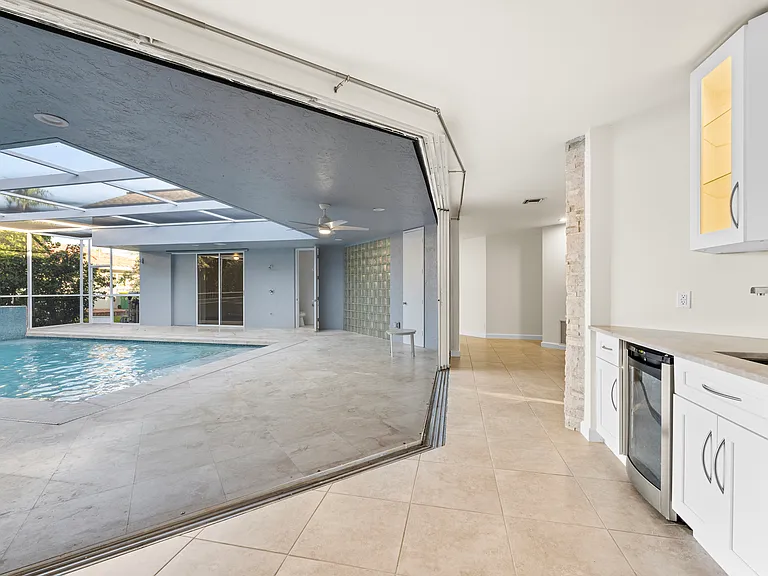 Rare courtyard design with direct pool access and views from throughout the home.