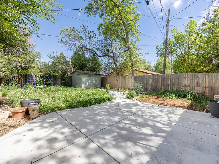 backyard with new patio, new fence, and established landscaping