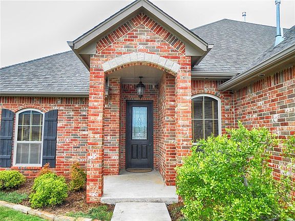 The covered porch and stone detail create a welcoming entry.
