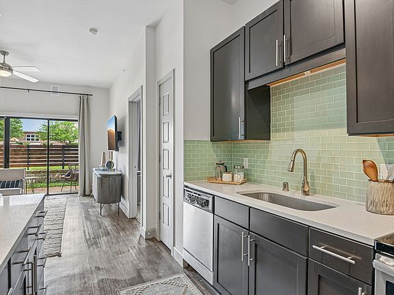Markethaus 3700 A modern kitchen with dark wood cabinets and a white countertop.