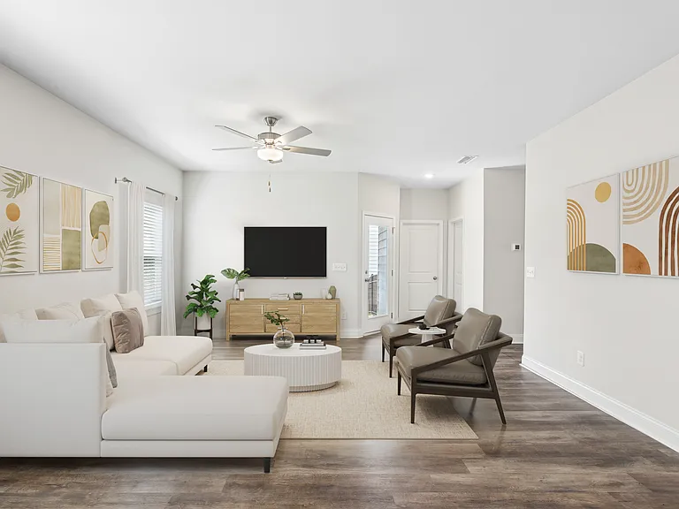 Living room with large window letting in a ton of natural light.