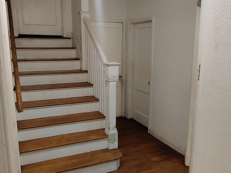 Staircase leading to upstairs bedroom and restroom.