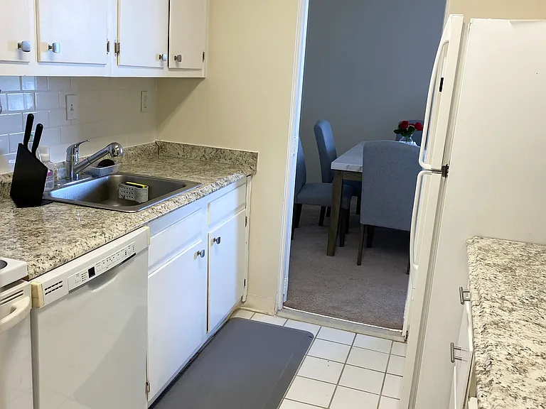 Kitchen looking into dining area showing tiled back splash