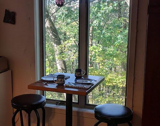 Small eating nook overlooking private wooded area.