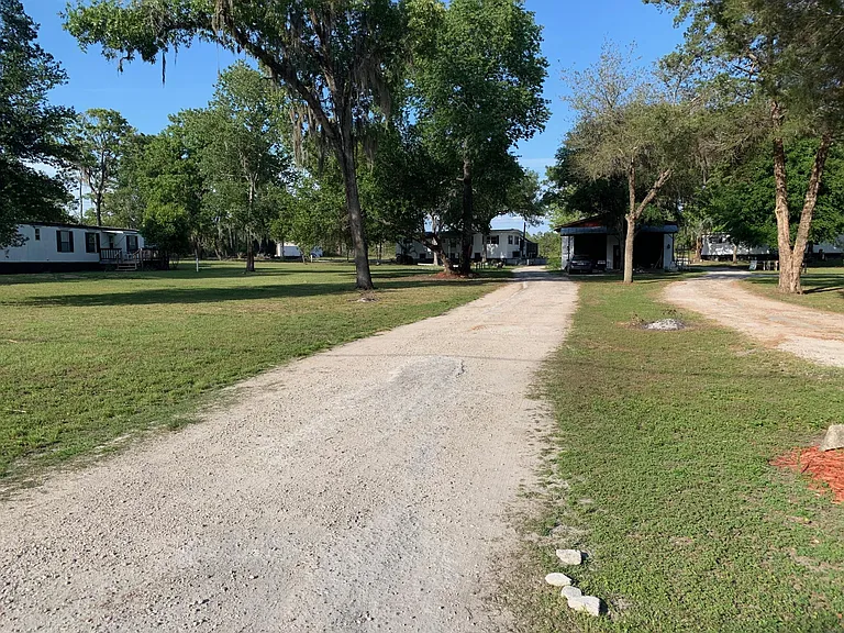 The residence sits pleasantly back from the paved street.