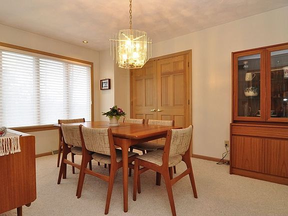 Formal dining room adjoins kitchen. Double doors lead to sun room.