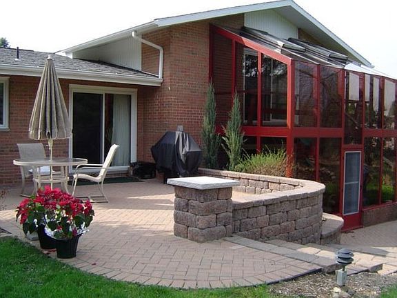 Beautiful new brick patio and walkways surround the back of the home