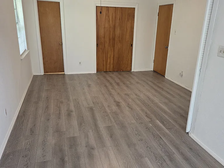 The room size is actually the size of two rooms with separate overhead lights separated by a large overhead ceiling fan.