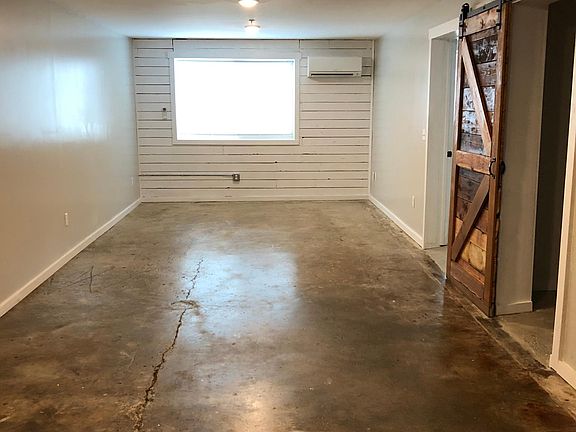 Looking in from the main entrance; large open living room.