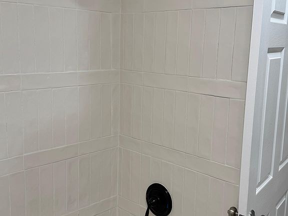Updated shower with modern tile and fixtures