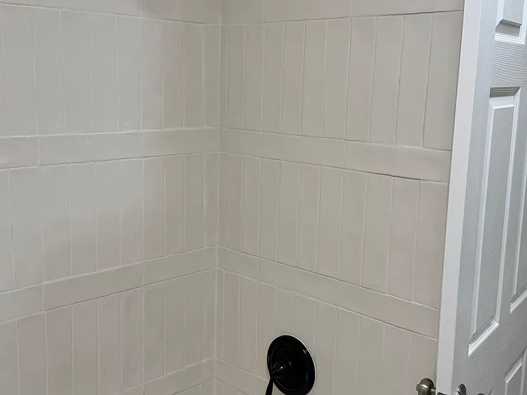Updated shower with modern tile and fixtures