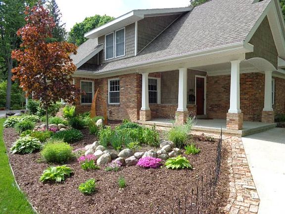 Closer view of the covered front porch and landscaping.