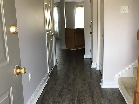 Entry way leads to kitchen and family room with new hardwood