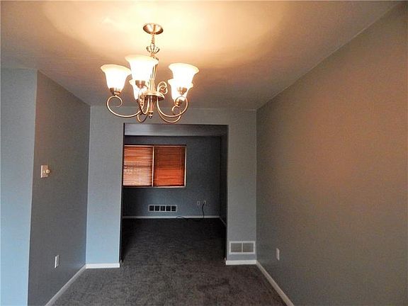 DINING ROOM WITH NEW WALL TO WALL AND CEILING LIGHT FIXTURE OFF THE LIVING ROOM.