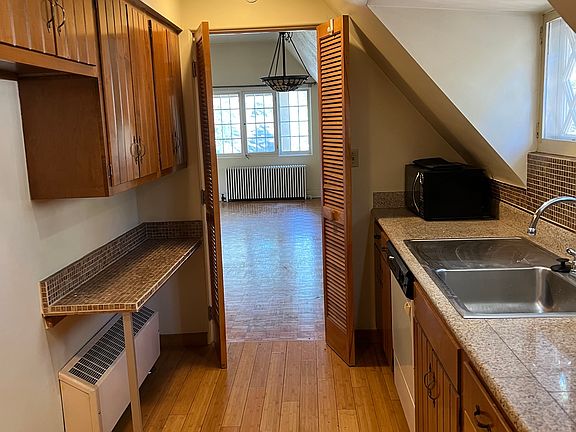 Spacious kitchen with ample counter tops, full size appliances, including a dishwasher and microwave. A deep cottage window, and a full size pantry with an abundance of cabinets and drawers.