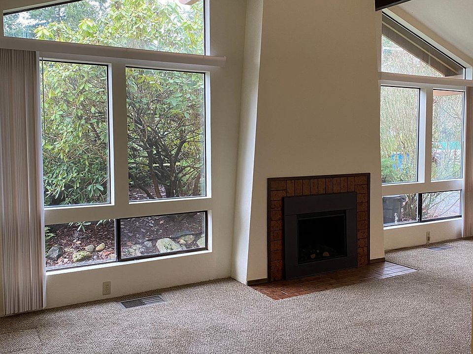 High ceiling living room with fireplace.
