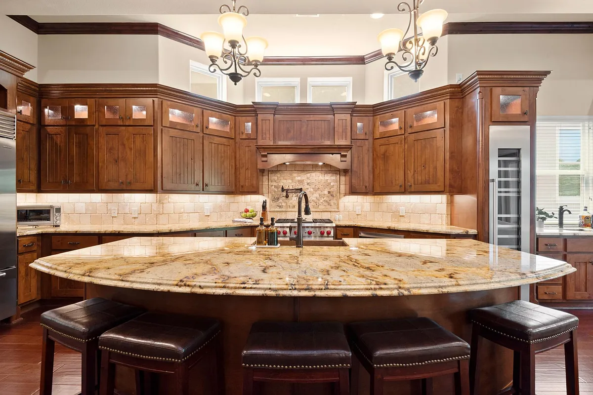 Kitchen, refrigerator, stove/oven. High end Wolf Appliances. Copper sink. Under cabinet lighting. See wet bar and wine cooler on right. - 106 La Vie Dr