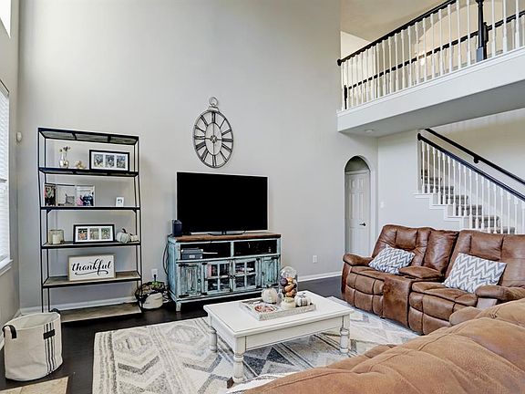 Large family room with wood floors, 2 story ceiling, and fireplace!