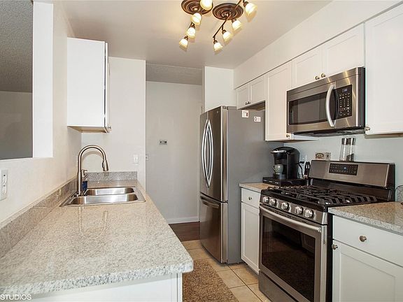 Brand new kitchen with Samsung appliances and granite countertops.