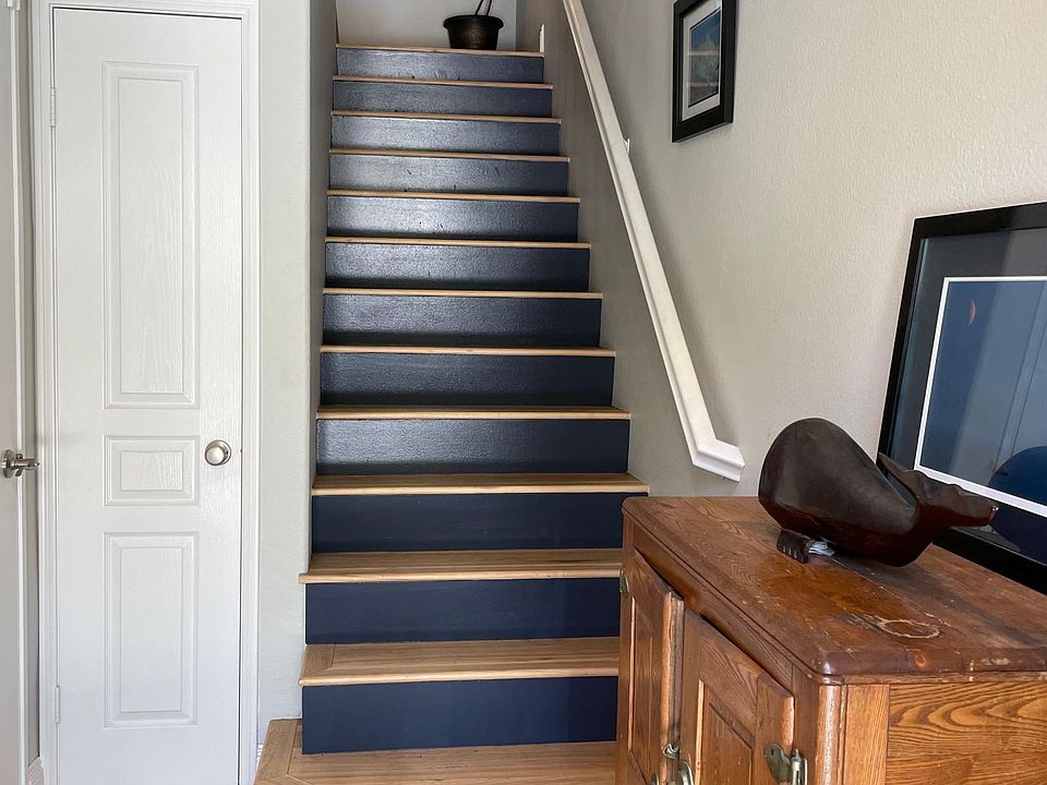 Entry, coat closet, and staircase to living room/kitchen