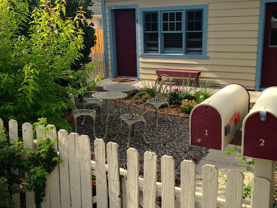 Front yard is adorable for morning coffee - there is just one patio table and two chairs now. Plus the bench.