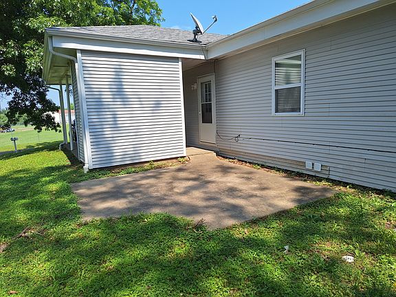 Concrete pad behind the storage shed for outdoor seating or grilling.