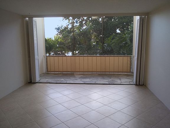 Spacious living room with travertine floors and large lanai