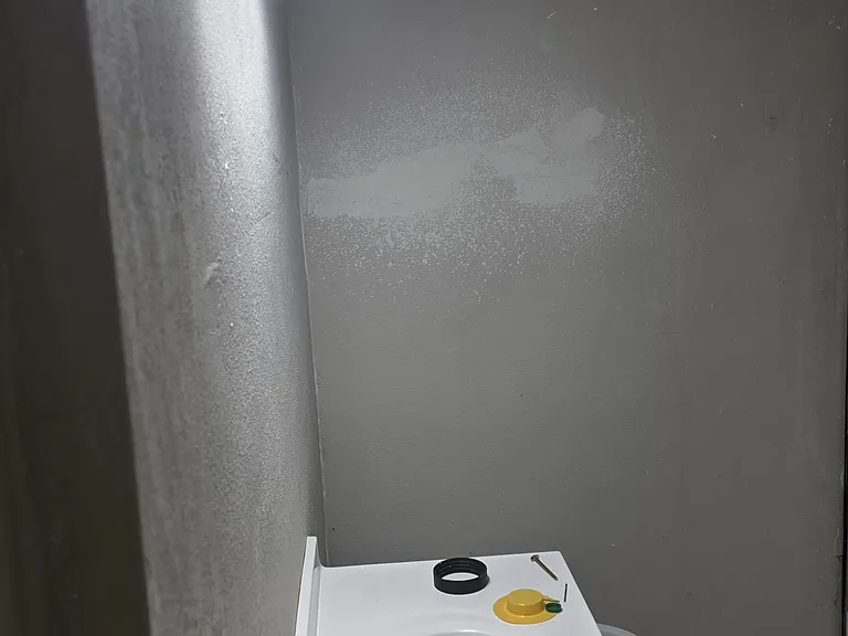 Secondary bathroom with same modern light fixtures as primary bathroom, single vanity and marble tiled tub/shower