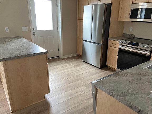 Kitchen, large pennisula for meal prep and eating. Lots of storage.