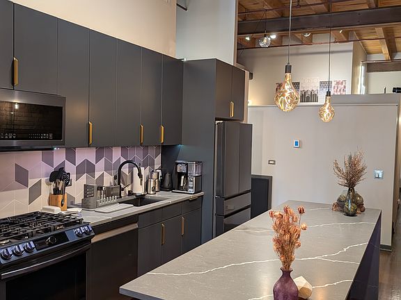 Kitchen is fully built for functionality: Island has all drawers. Pull out shelves. Pegboard organizers. Lighting under cabinets and island countertop.