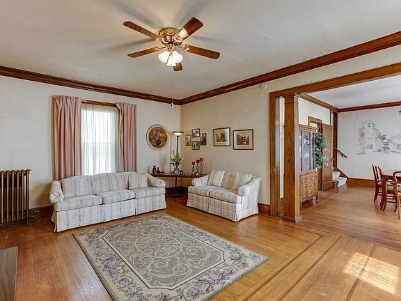 Good sized living room with original wood inlaid floors.