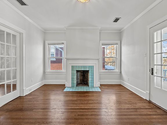 This is the living room. Plenty of natural light. And wonderful symmetry .
The fireplace is not useable, but provides great ambiance. The stunning aqua tiles are original.