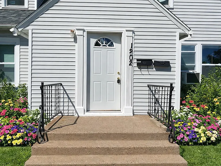 Spacious primary bedroom with large windows and plenty of room for a full bedroom furniture set.