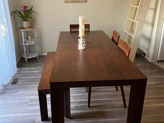 Dining area off kitchen, near loft ladder.