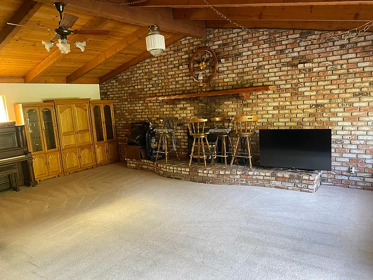 Huge family room with gas insert fireplace, wood beamed ceiling, access to backyard