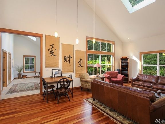This is the definition of a Great Room!  The soaring vaulted ceiling rises up to over 30ft, flooding the home with natural light