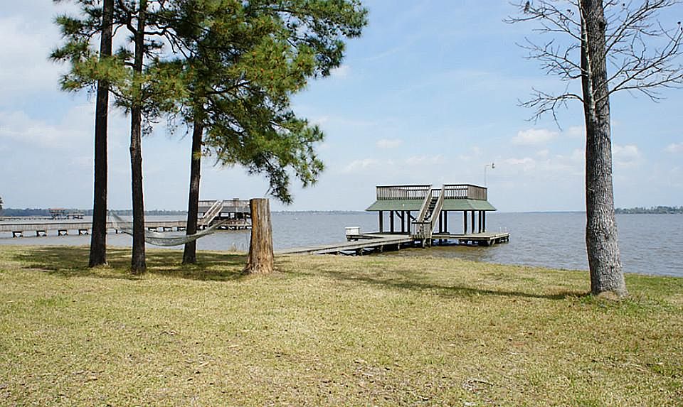 65" pier leads to the boathouse and deck overlooking Lake Houston. Enjoy the summer breeze from the shaded hammock.