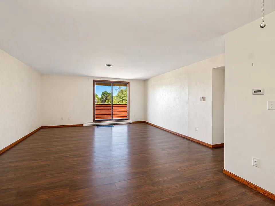 Walk-Out To Private Balcony - Photo has been digitally altered to show new flooring being installed. Color is not exact.